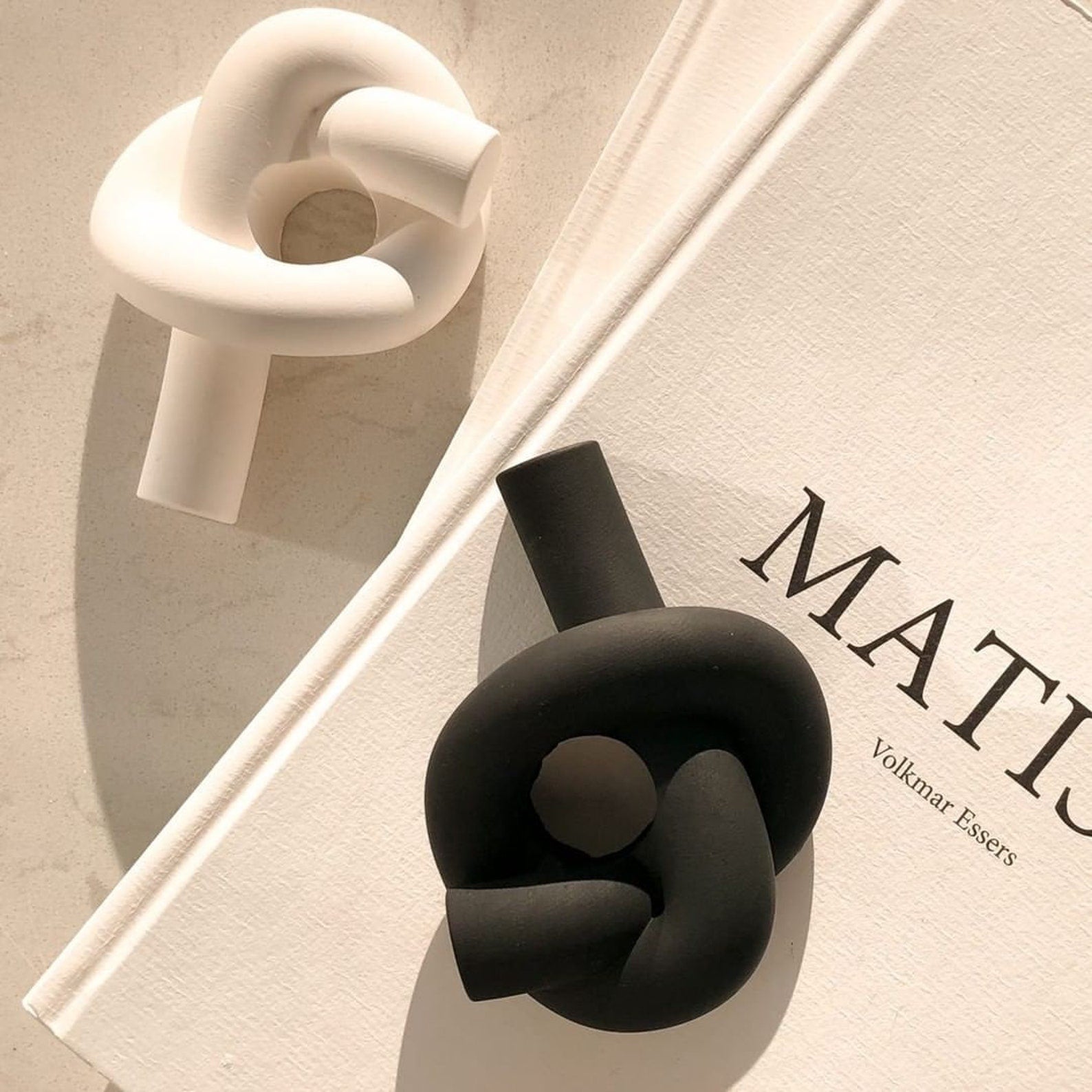 white and black knot candle holder